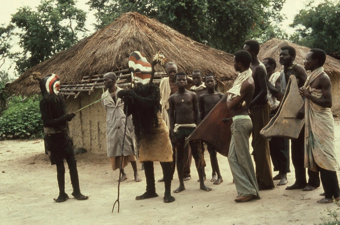 Bwadi bwa kifwebe ensemble in Luama village, Munga chiefdom, Eastern Songye. Elder’s mask Lobo (right) and youth’s mask Nkwali (left) with drummers and singers. Photo: © DuNja hErSak, 1978